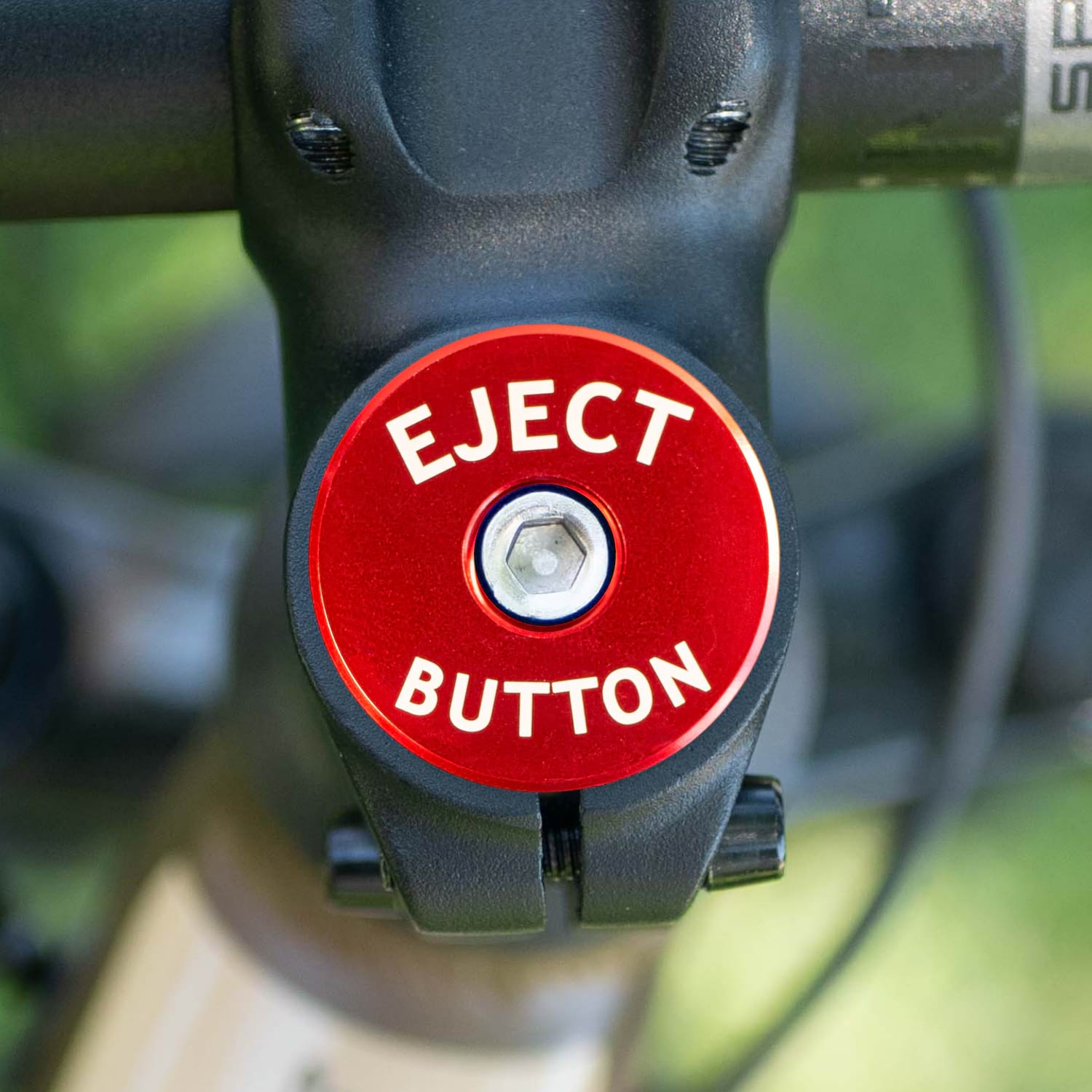 red_eject_button_headset_cap_on_bike